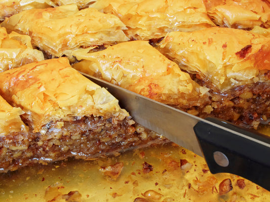 A tray of freshly-baked Zymi baklava, golden filo soaked in honey syrup