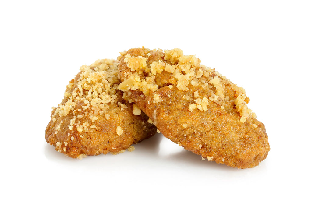 Two Zymi melomakarona, Greek honey cookies topped with chopped walnuts