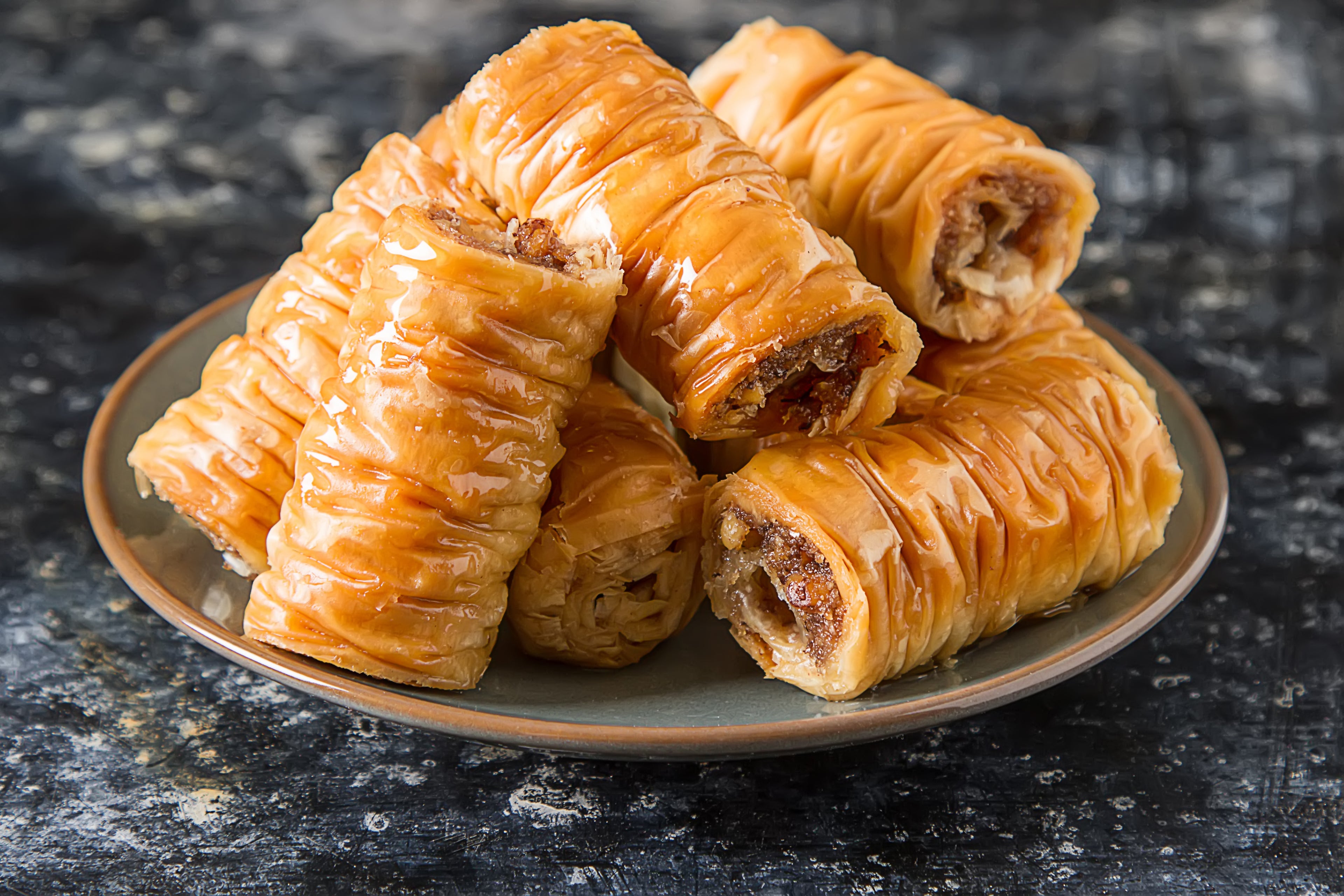 Bite-size Greek baklava rolls with flaky pastry and syrupy walnuts