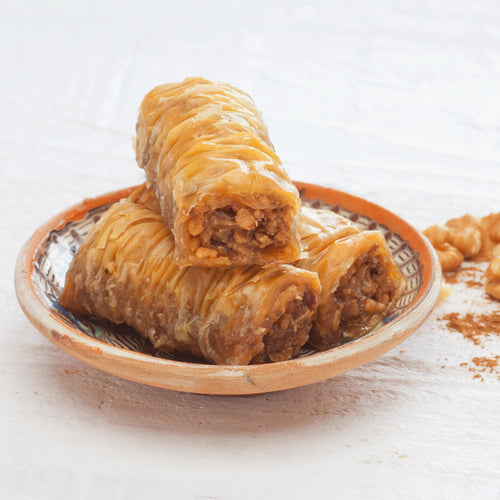 Zymi baklava rolls arranged in a gift box, ready to share